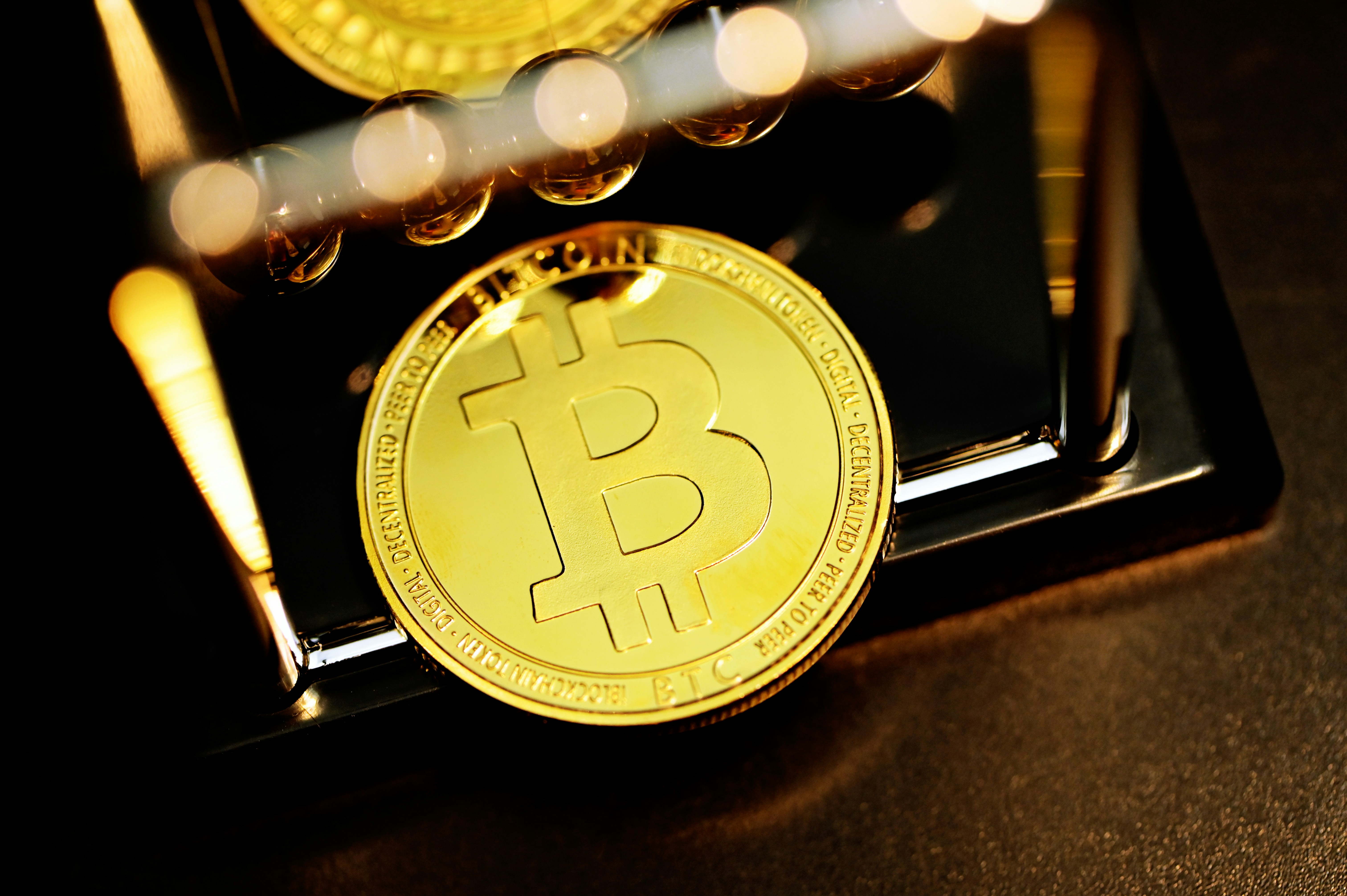 gold round coin on black surface