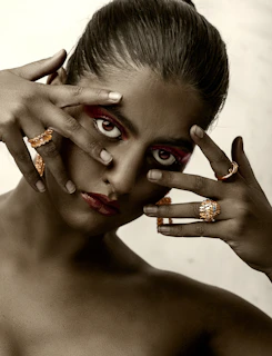 A close-up of a model’s face with expressive makeup and intense gaze.