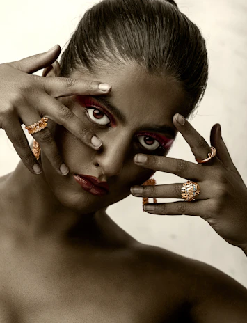 A close-up of a model’s face with expressive makeup and intense gaze.