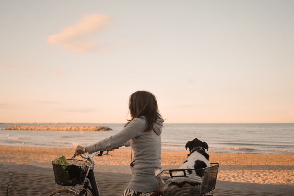 woman in gray sweater sitting on black steel bench during daytime