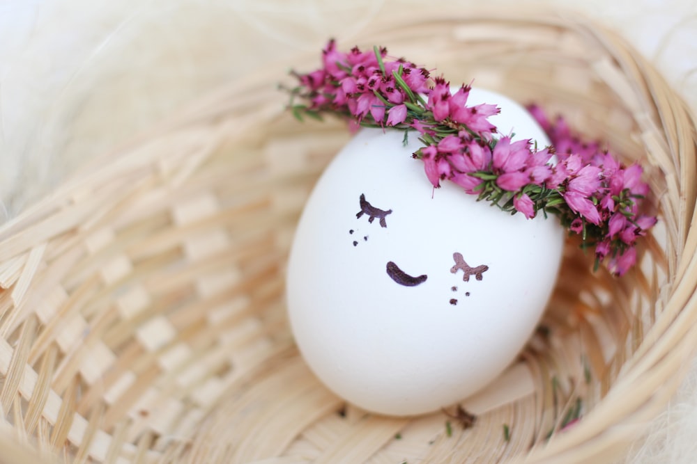 purple flowers on white ceramic vase