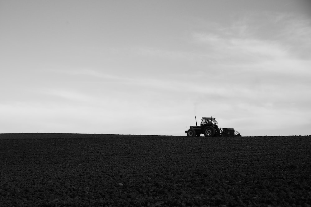 grayscale photo of a truck on a field