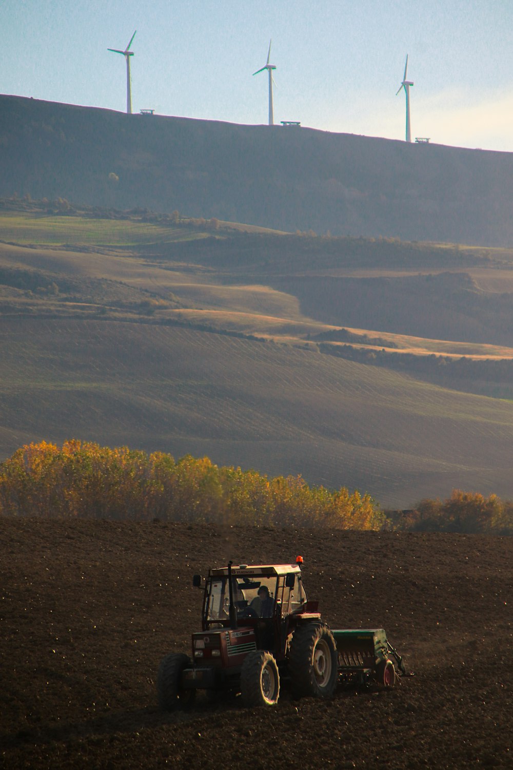 yellow and black tractor on green grass field during daytime