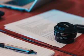 black camera lens on white printer paper