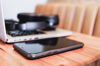 a laptop computer sitting on top of a wooden desk