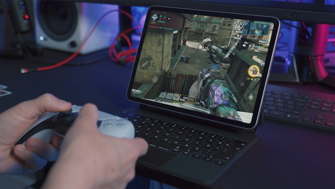 black tablet computer with keyboard, Playing Call of Duty: Mobile online game on iPad<p></figure>