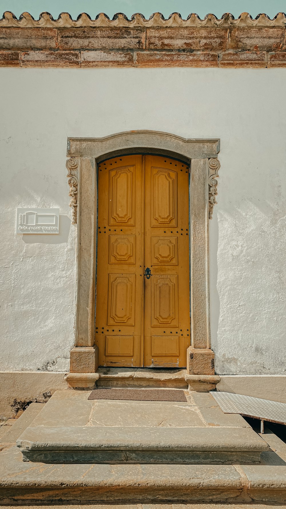 brown wooden door on white concrete wall