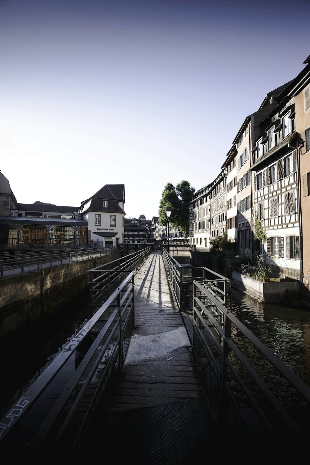 brown concrete building beside river during daytime