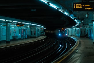 red train on train station during night time