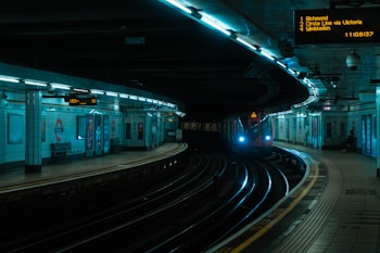 red train on train station during night time