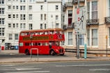 red double decker bus on road during daytime