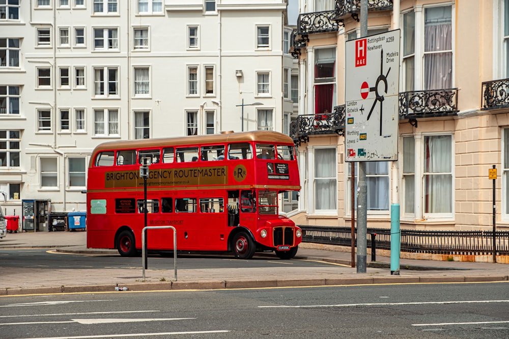 red double decker bus on road during daytime