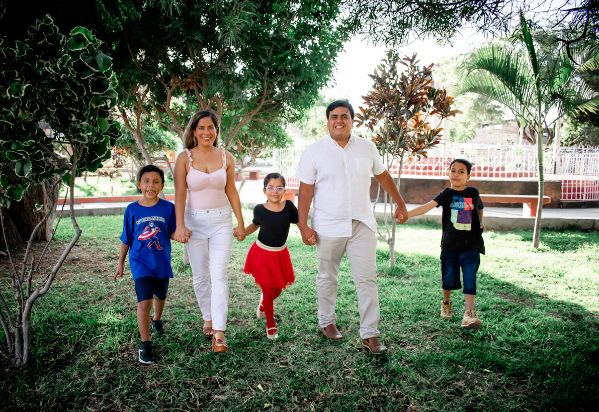A group of friends holding hands and smiling together at a park in San Antonio.