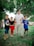 A happy dad playing with his children in a park, wearing comfortable casual clothing.