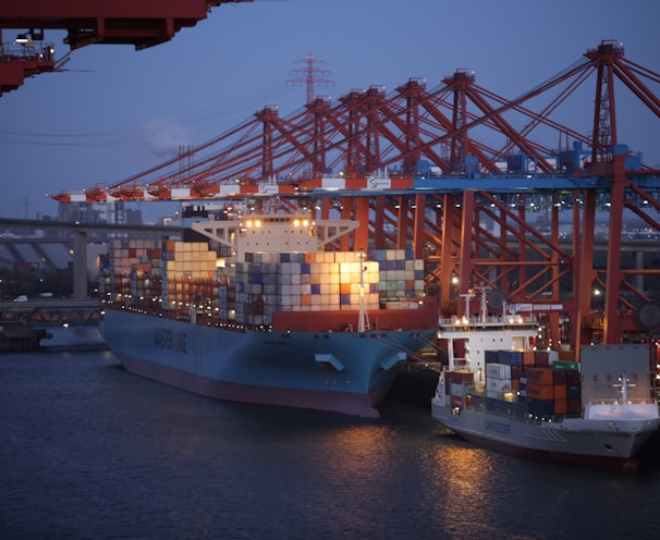 blue and red cargo ship on sea during daytime