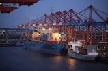 blue and red cargo ship on sea during daytime