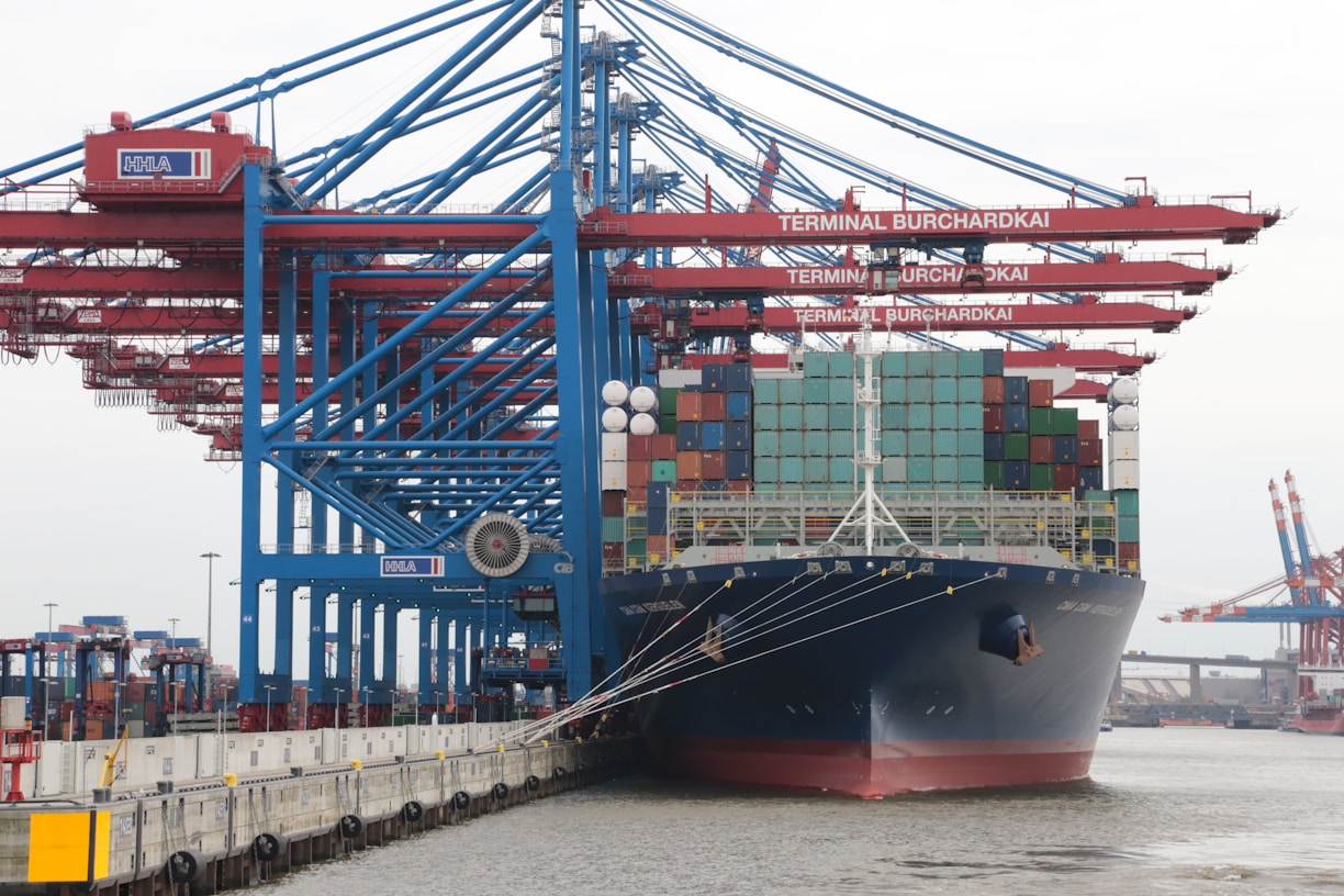blue and red cargo ship on sea during daytime