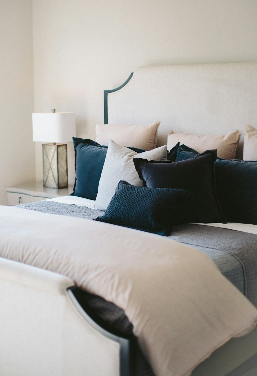 black and white throw pillows on white bed