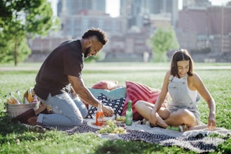 man in black t-shirt sitting on woman in white tank top and man in black