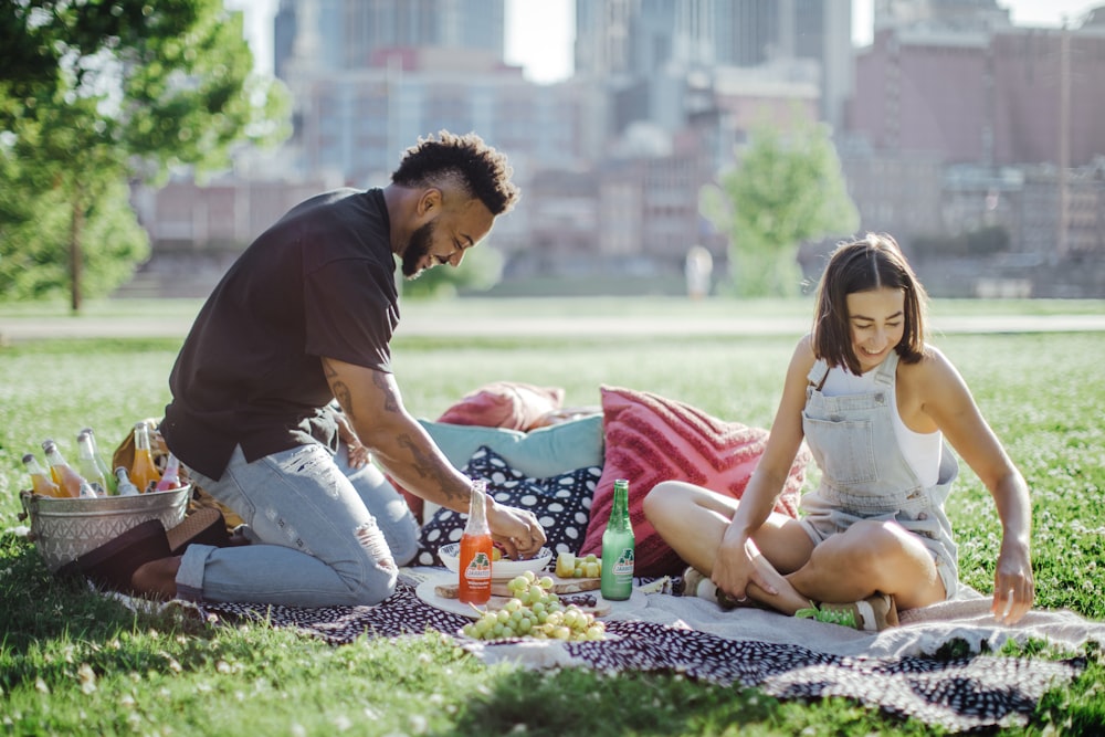 man in black t-shirt sitting on woman in white tank top and man in black