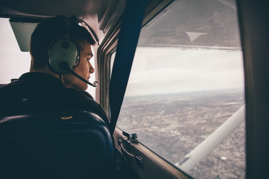person in black jacket wearing black headphones, Co-Pilot flying over Indiana
