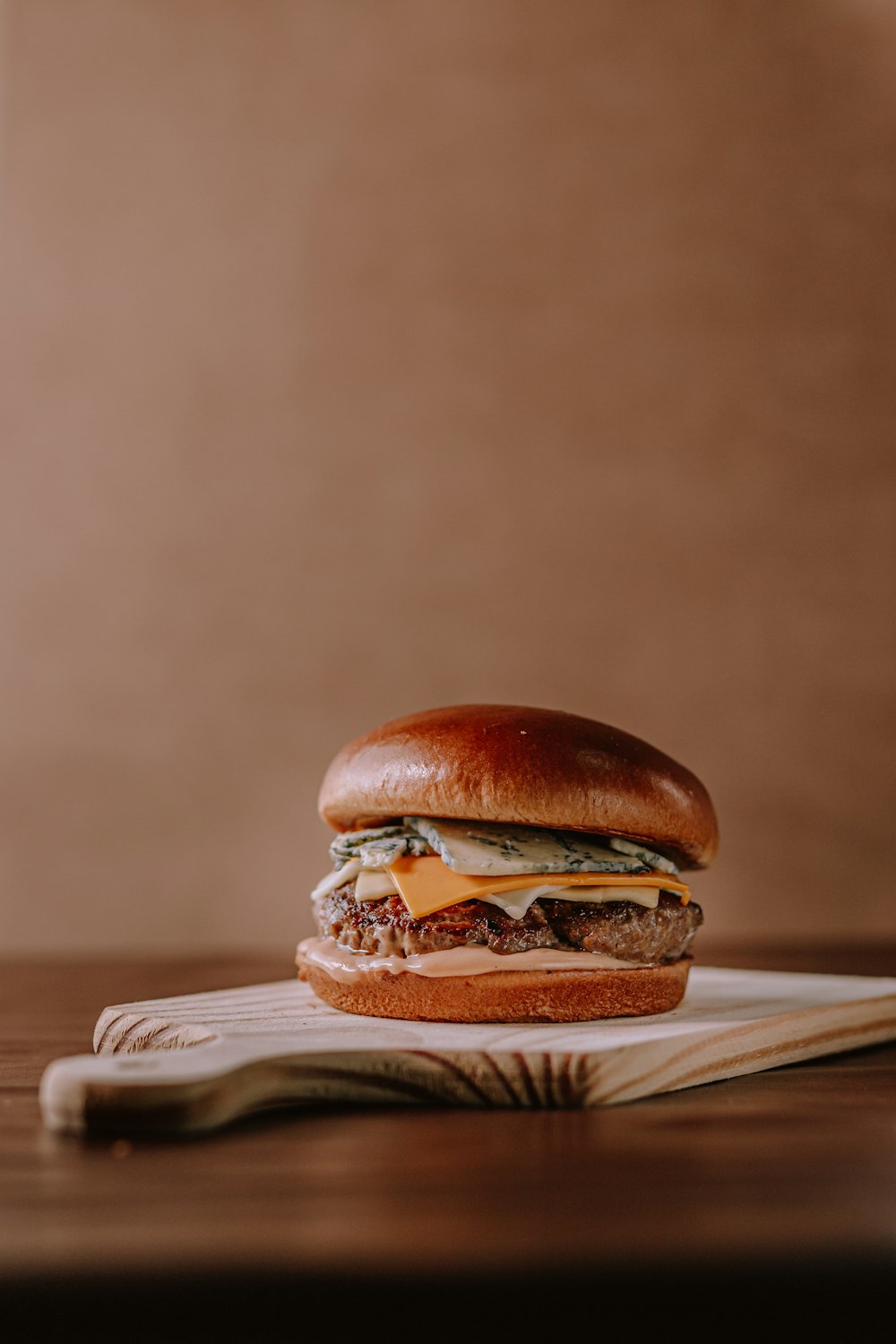 brown burger on white ceramic plate