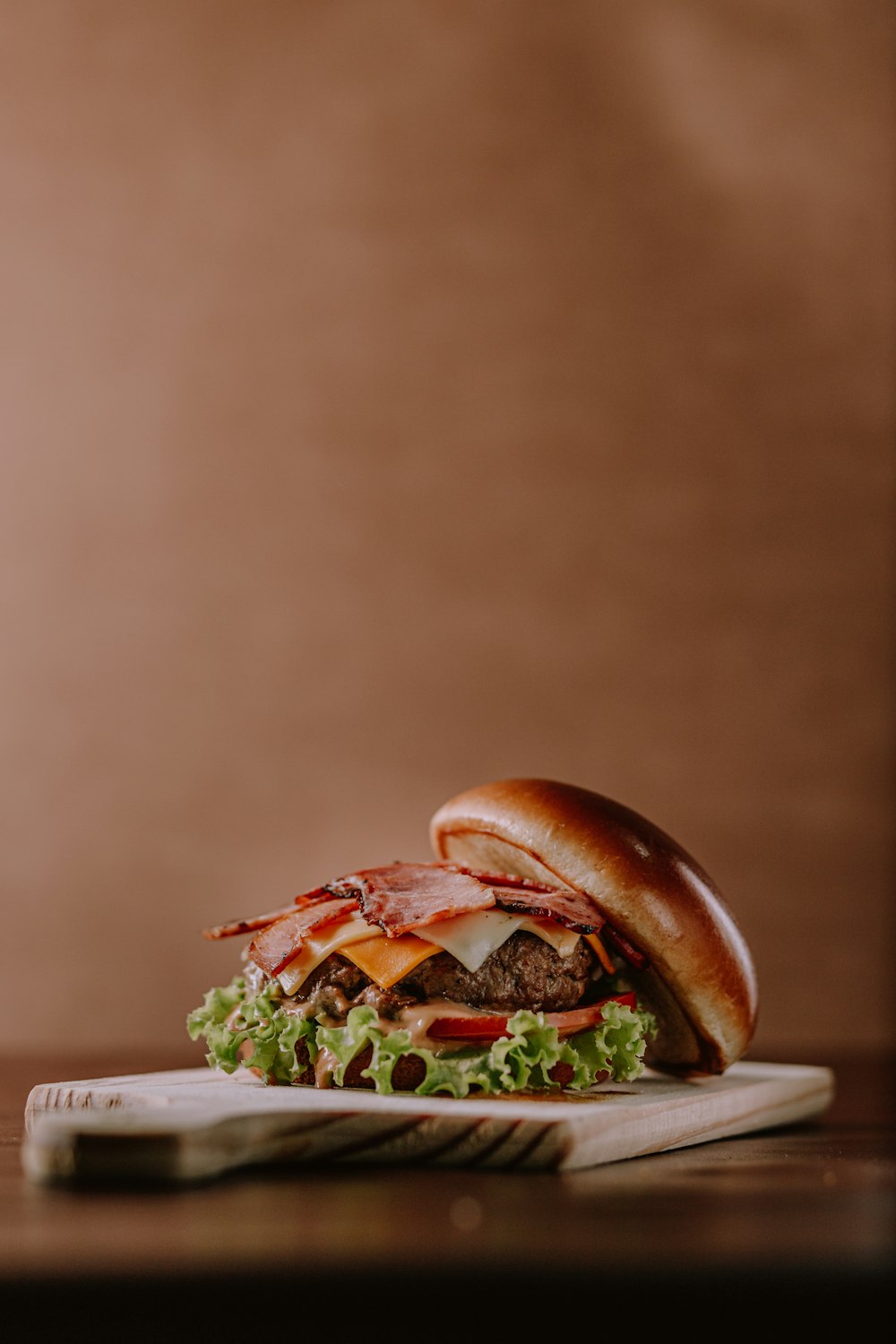 burger with lettuce and tomato on white ceramic plate