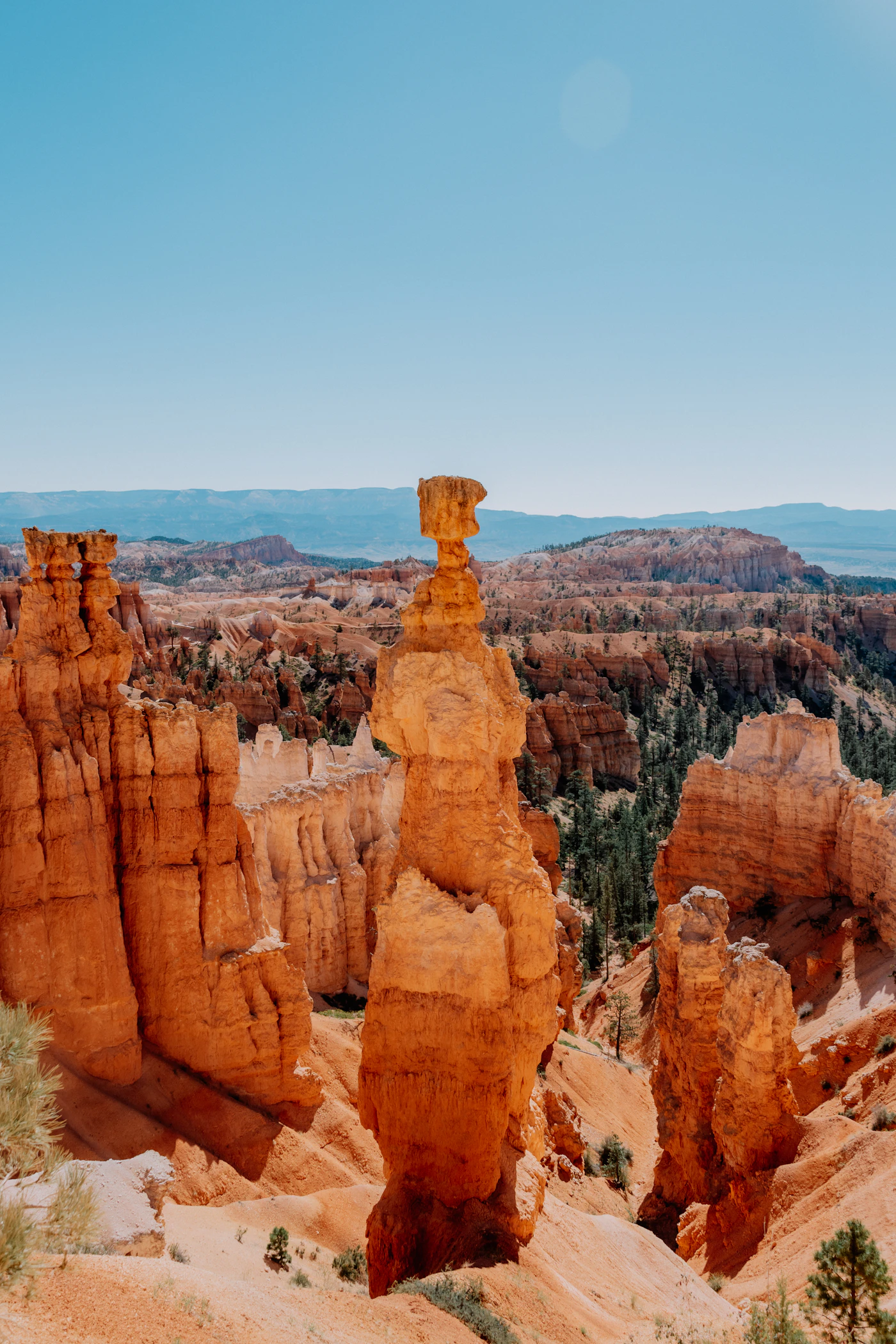 Orange and white hoodoo rock spires under a deep blue sky at Bryce Canyon, Utah