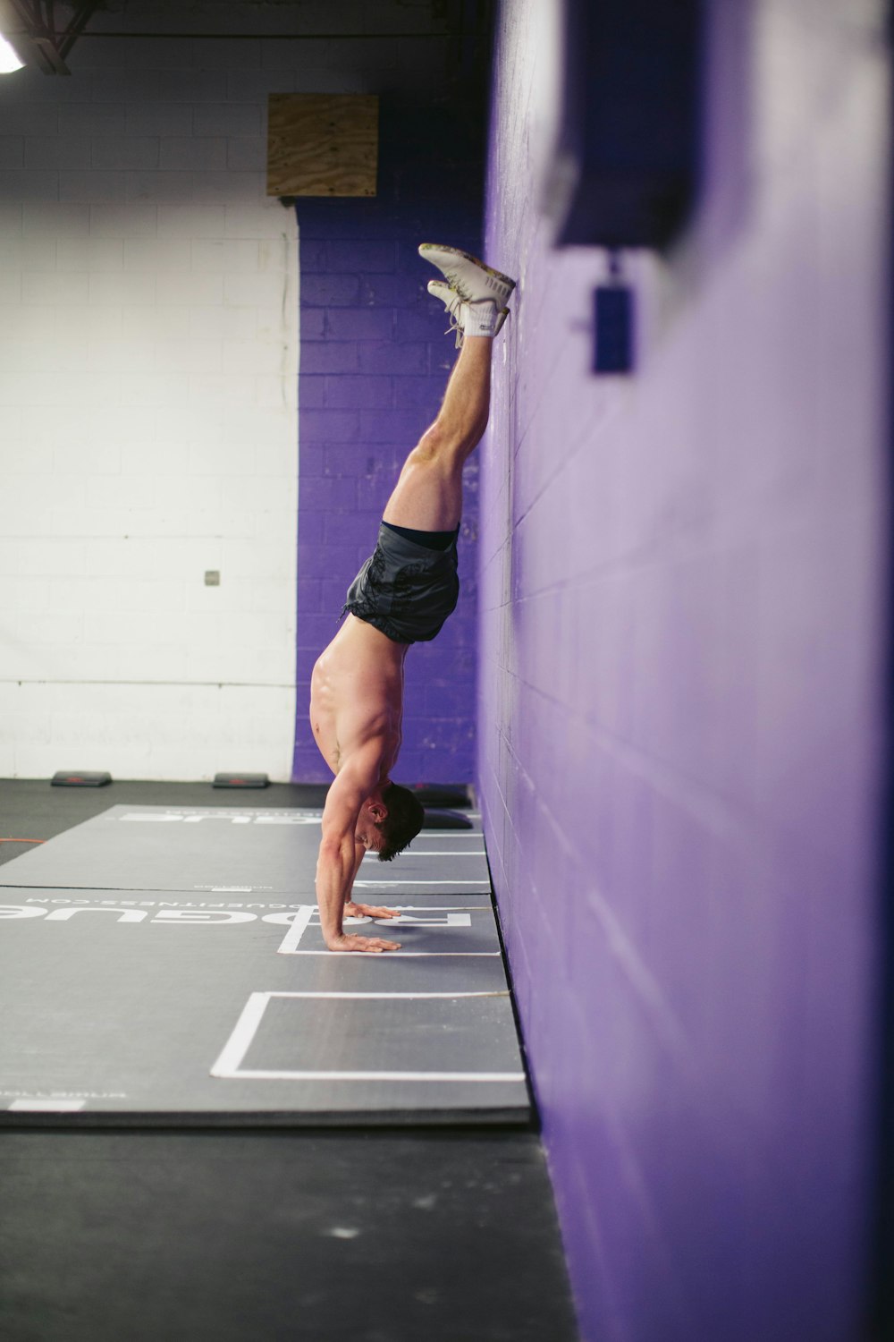 woman in black tank top and black shorts doing yoga