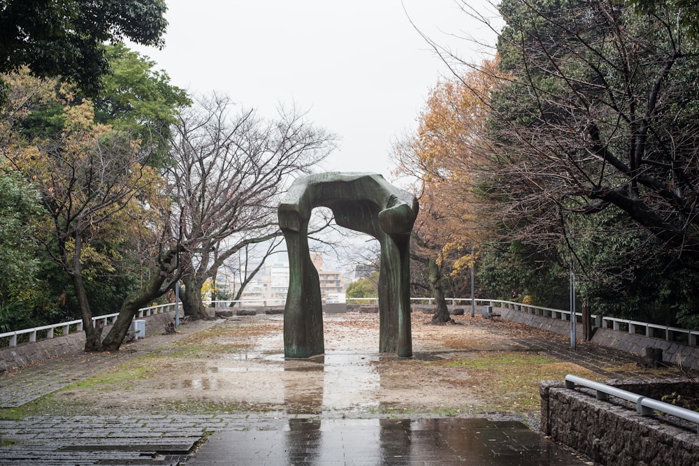 gray concrete statue near trees during daytime