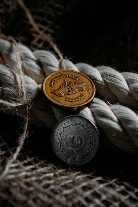A close-up of a warm copper coin resting on a textured wooden surface, symbolizing value and timeless guidance.