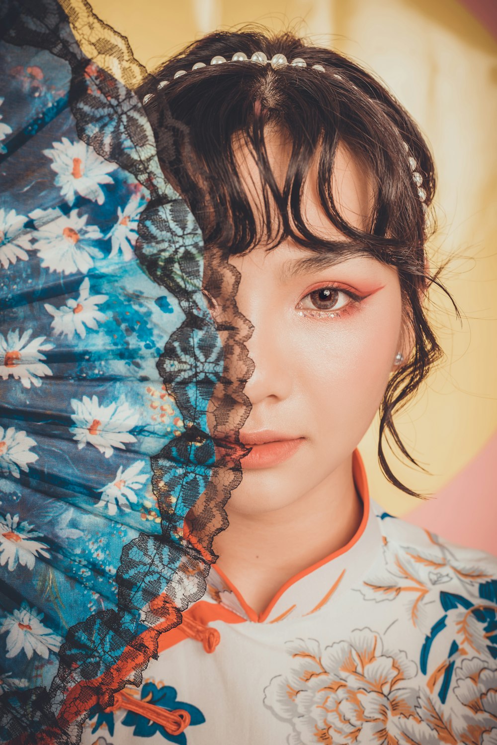 woman in white blue and red floral shirt