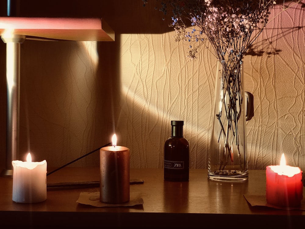 black and brown bottle on brown wooden table