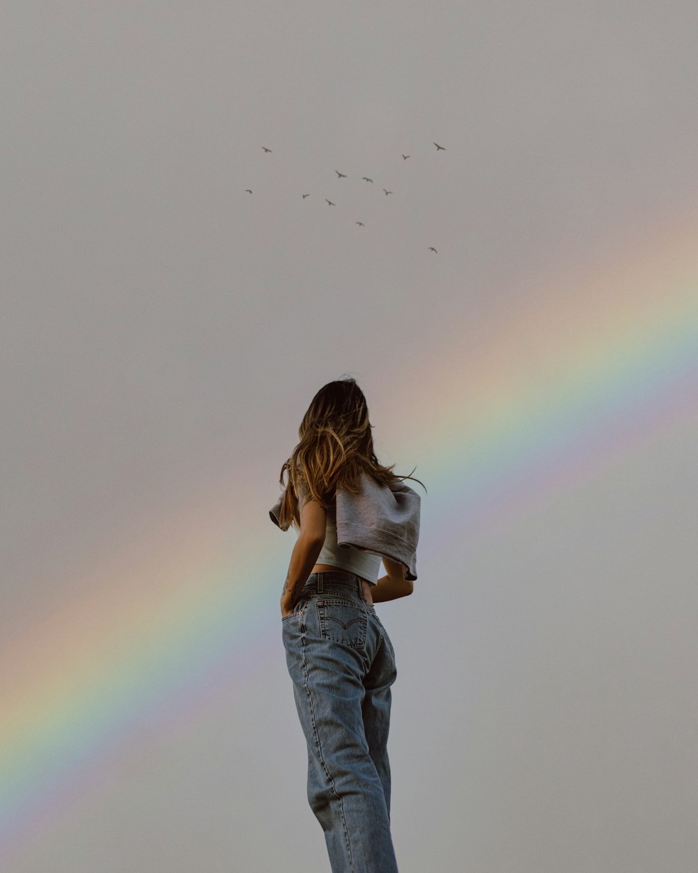 woman in blue denim jacket and blue denim jeans standing