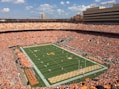 green football field under blue sky during daytime