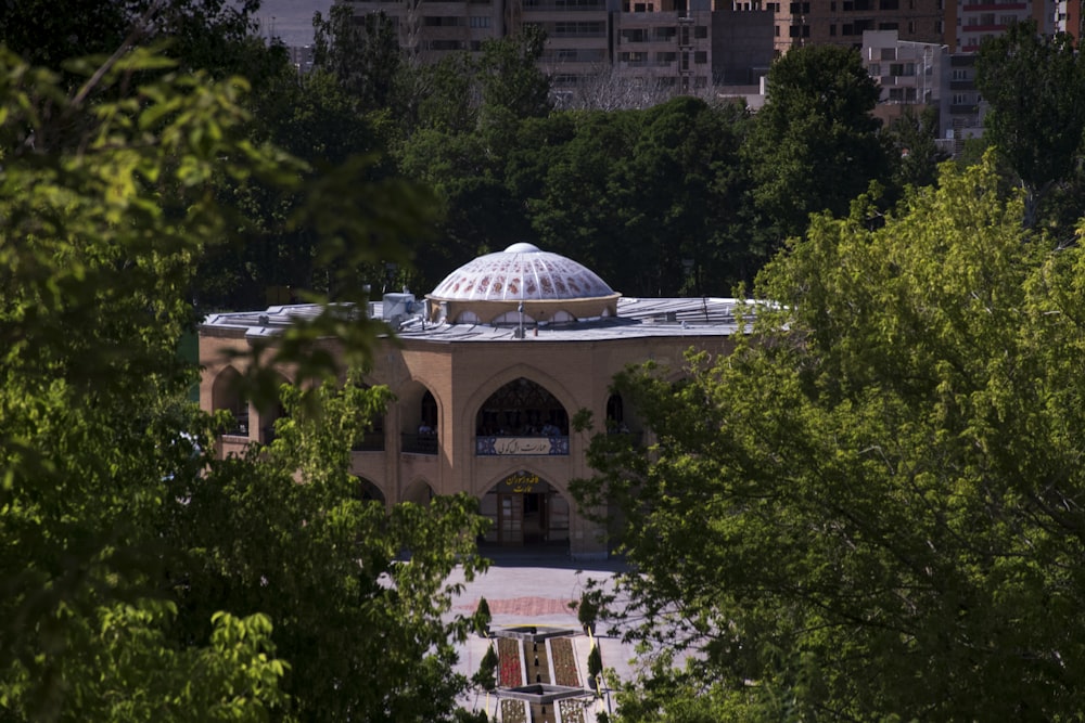 white dome building surrounded by green trees during daytime