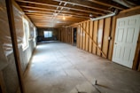 Modern basement renovation with clean walls and updated heating units.