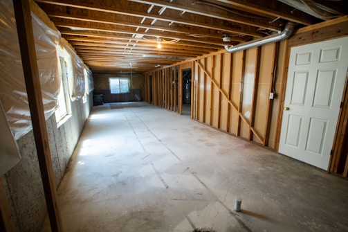 Wide view of a crawl space before and after vapor barrier installation.