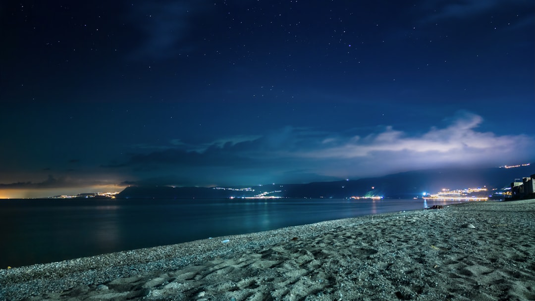 body of water under blue sky during night time