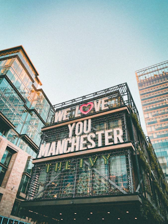 low angle photography of brown concrete building under white sky during daytime
