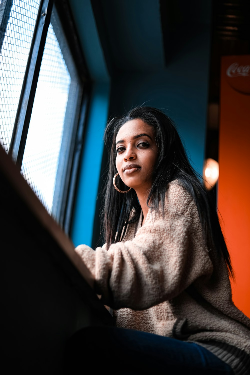 woman in brown sweater smiling