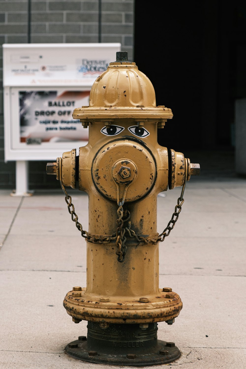 brass colored fire hydrant on sidewalk during daytime