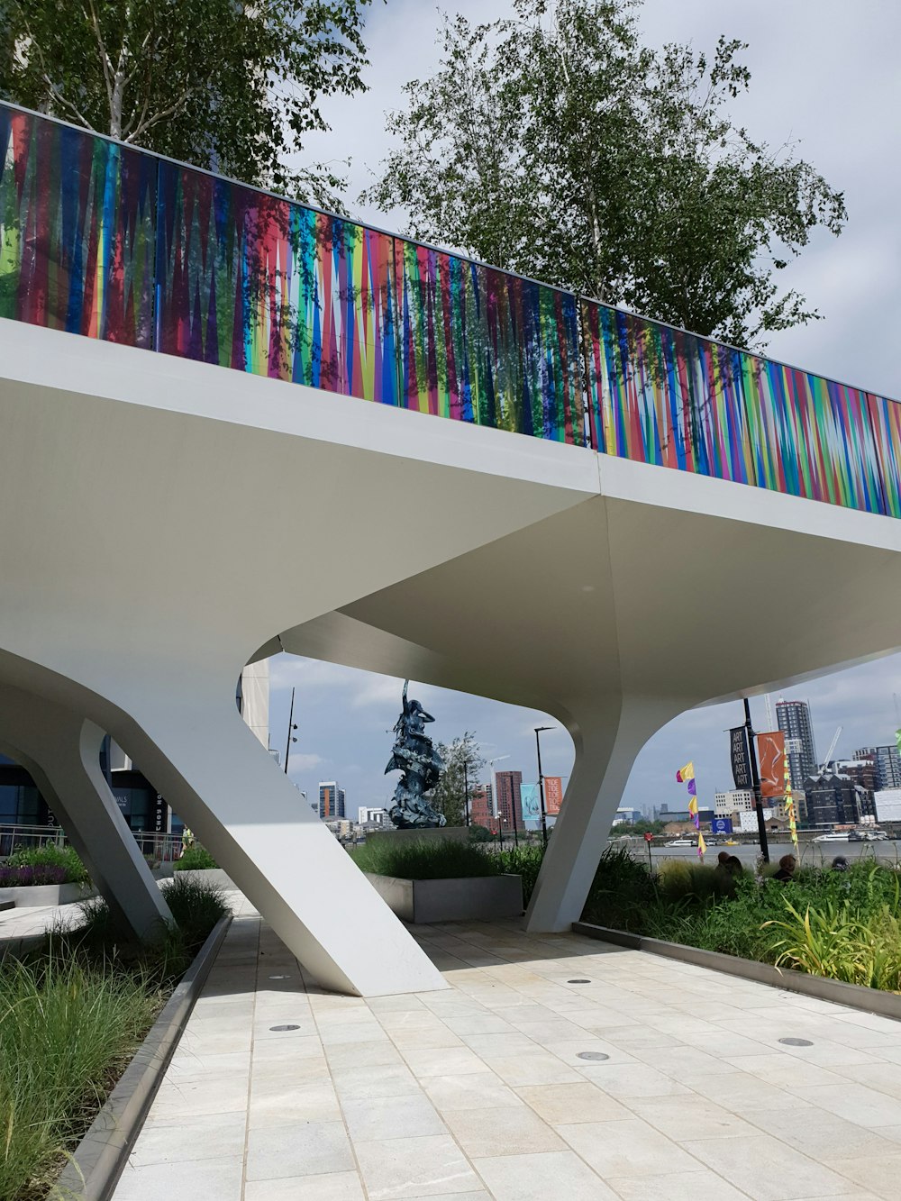 white concrete building with multi colored wall art during daytime