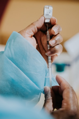 person holding clear glass tube