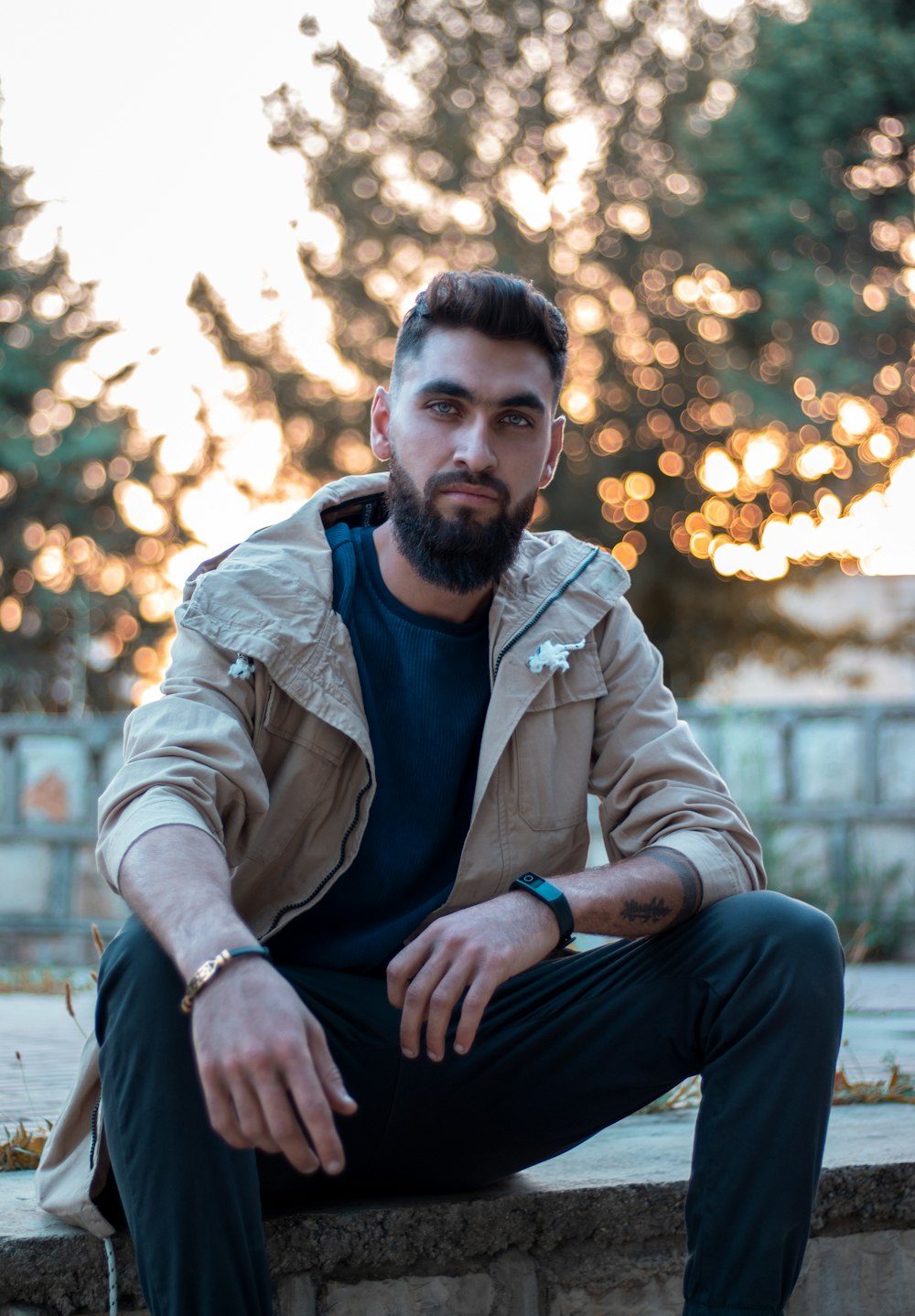 man in brown jacket sitting on brown wooden bench