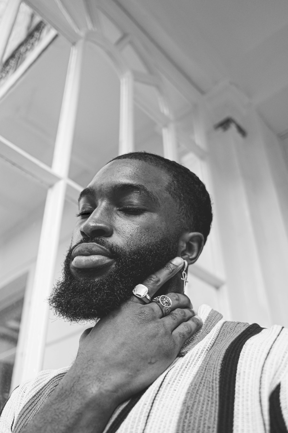 man in white and black striped shirt