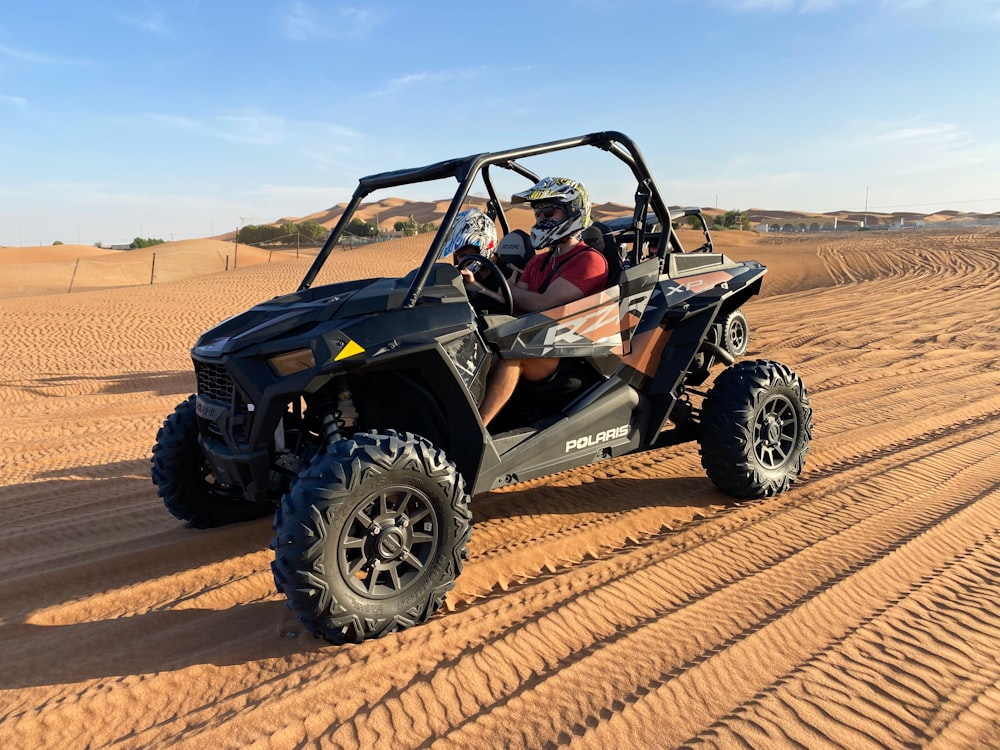 black and blue jeep wrangler on desert during daytime
