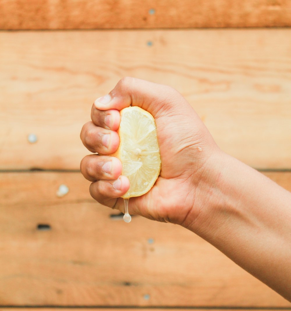 person holding heart shaped white ornament