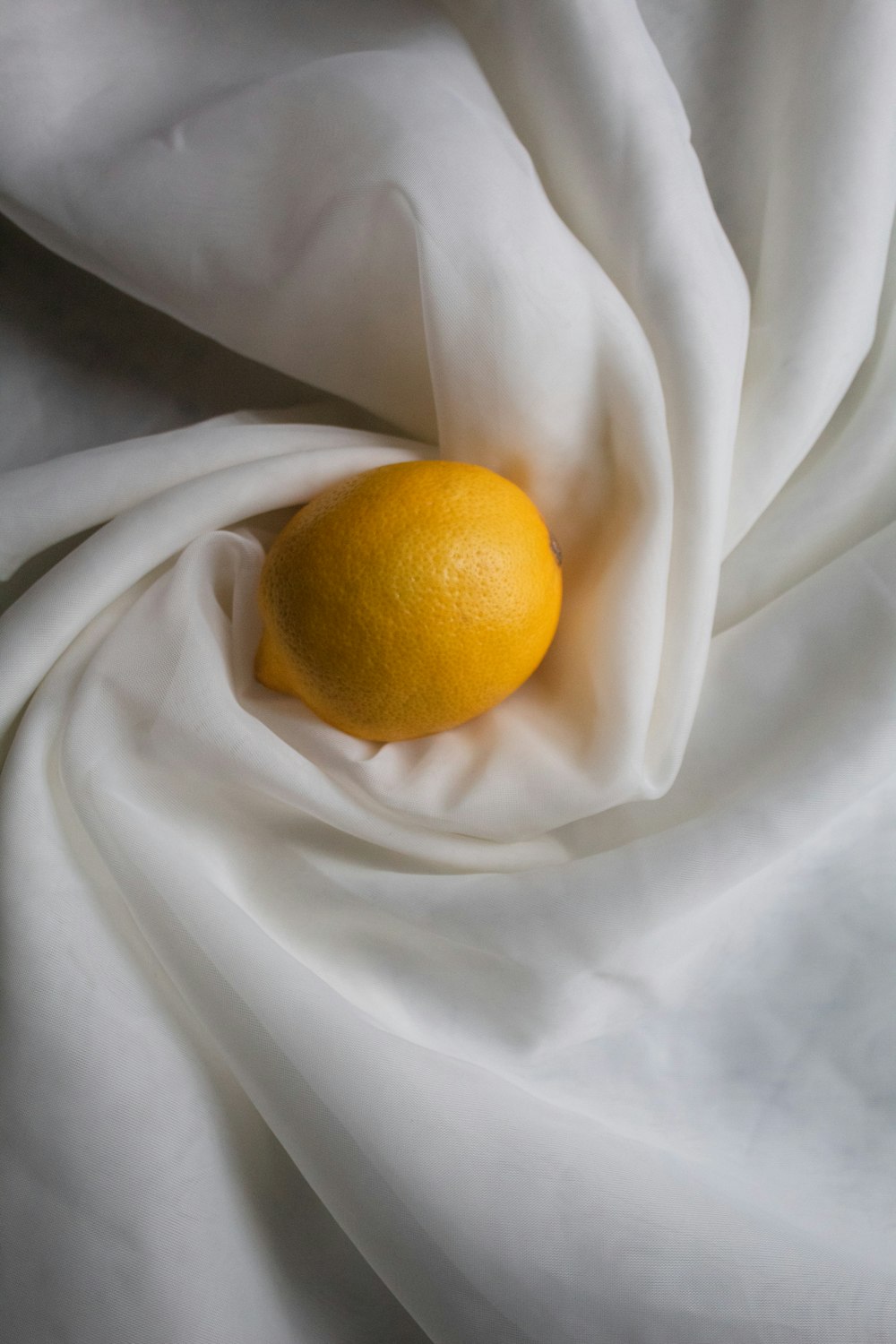 yellow lemon on white textile