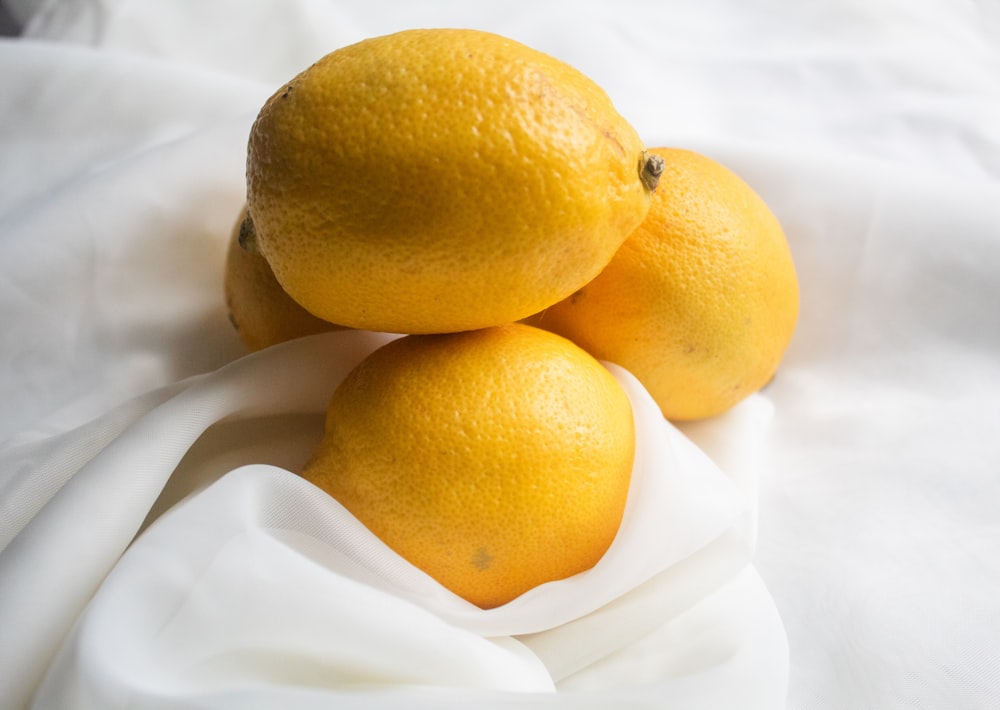 yellow lemon on white textile